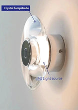 Load image into Gallery viewer, Inspira Lifestyles | Onda Crystal Wall Light with round optical crystal disc and chrome center, mounted as a modern LED wall or ceiling sconce.
