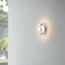 Load image into Gallery viewer, Inspira Lifestyles | Onda Crystal Wall Light with round optical crystal disc and chrome center, mounted as a modern LED wall or ceiling sconce.
