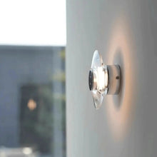 Load image into Gallery viewer, Inspira Lifestyles | Onda Crystal Wall Light with round optical crystal disc and chrome center, mounted as a modern LED wall or ceiling sconce.
