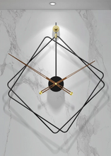 Load image into Gallery viewer, Oversized Thierry Wall Clock with minimalist iron frame and wooden arms, sculptural geometric wall clock as statement decor, modern wall clock styled in living room, large decorative wall clock in entryway, close-up of wooden hands on Thierry Wall Clock, contemporary geometric clock on neutral wall. Modern wall clock with gold accents on a marble wall
