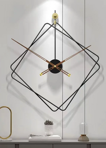 Oversized Thierry Wall Clock with minimalist iron frame and wooden arms, sculptural geometric wall clock as statement decor, modern wall clock styled in living room, large decorative wall clock in entryway, close-up of wooden hands on Thierry Wall Clock, contemporary geometric clock on neutral wall. Modern wall clock with black frame and gold accents on a white wall.