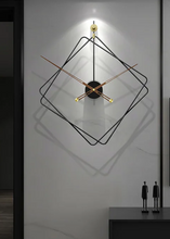 Load image into Gallery viewer, Oversized Thierry Wall Clock with minimalist iron frame and wooden arms, sculptural geometric wall clock as statement decor, modern wall clock styled in living room, large decorative wall clock in entryway, close-up of wooden hands on Thierry Wall Clock, contemporary geometric clock on neutral wall. Modern wall clock with geometric design on a white wall
