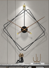 Load image into Gallery viewer, Oversized Thierry Wall Clock with minimalist iron frame and wooden arms, sculptural geometric wall clock as statement decor, modern wall clock styled in living room, large decorative wall clock in entryway, close-up of wooden hands on Thierry Wall Clock, contemporary geometric clock on neutral wall.
