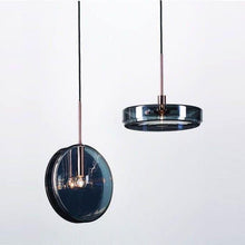 Load image into Gallery viewer, INSPIRA LIFESTYLES - Azura Blue Glass Pendant featuring translucent circular blue glass, modern sculptural pendant lighting with minimalist architectural design, ambient blue glass pendant for dining rooms, kitchen islands, bedrooms, living rooms, entryways, restaurants, boutique hotels, and luxury contemporary interiors
