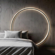 Load image into Gallery viewer, INSPIRA LIFESTYLES – Minimalist Metal Ring Light, a modern circular LED wall light with sleek sculptural design. This versatile wall sconce doubles as accent lighting and wall art, perfect as a bedroom light above a headboard, a living room statement piece, or a minimalist hallway fixture. Contemporary ring light crafted in metal with soft LED illumination, ideal for modern interiors seeking sculptural lighting, circle lights, or functional yet artistic wall sconces.
