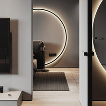 Load image into Gallery viewer, INSPIRA LIFESTYLES – Minimalist Metal Ring Light, a modern circular LED wall light with sleek sculptural design. This versatile wall sconce doubles as accent lighting and wall art, perfect as a bedroom light above a headboard, a living room statement piece, or a minimalist hallway fixture. Contemporary ring light crafted in metal with soft LED illumination, ideal for modern interiors seeking sculptural lighting, circle lights, or functional yet artistic wall sconces.
