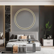 Load image into Gallery viewer, INSPIRA LIFESTYLES – Minimalist Metal Ring Light, a modern circular LED wall light with sleek sculptural design. This versatile wall sconce doubles as accent lighting and wall art, perfect as a bedroom light above a headboard, a living room statement piece, or a minimalist hallway fixture. Contemporary ring light crafted in metal with soft LED illumination, ideal for modern interiors seeking sculptural lighting, circle lights, or functional yet artistic wall sconces.
