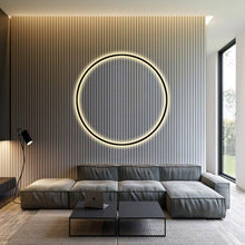Load image into Gallery viewer, INSPIRA LIFESTYLES – Minimalist Metal Ring Light, a modern circular LED wall light with sleek sculptural design. This versatile wall sconce doubles as accent lighting and wall art, perfect as a bedroom light above a headboard, a living room statement piece, or a minimalist hallway fixture. Contemporary ring light crafted in metal with soft LED illumination, ideal for modern interiors seeking sculptural lighting, circle lights, or functional yet artistic wall sconces.
