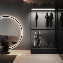 Load image into Gallery viewer, INSPIRA LIFESTYLES – Minimalist Metal Ring Light, a modern circular LED wall light with sleek sculptural design. This versatile wall sconce doubles as accent lighting and wall art, perfect as a bedroom light above a headboard, a living room statement piece, or a minimalist hallway fixture. Contemporary ring light crafted in metal with soft LED illumination, ideal for modern interiors seeking sculptural lighting, circle lights, or functional yet artistic wall sconces.
