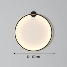 Load image into Gallery viewer, INSPIRA LIFESTYLES – Minimalist Metal Ring Light, a modern circular LED wall light with sleek sculptural design. This versatile wall sconce doubles as accent lighting and wall art, perfect as a bedroom light above a headboard, a living room statement piece, or a minimalist hallway fixture. Contemporary ring light crafted in metal with soft LED illumination, ideal for modern interiors seeking sculptural lighting, circle lights, or functional yet artistic wall sconces.
