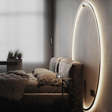 Load image into Gallery viewer, INSPIRA LIFESTYLES – Minimalist Metal Ring Light, a modern circular LED wall light with sleek sculptural design. This versatile wall sconce doubles as accent lighting and wall art, perfect as a bedroom light above a headboard, a living room statement piece, or a minimalist hallway fixture. Contemporary ring light crafted in metal with soft LED illumination, ideal for modern interiors seeking sculptural lighting, circle lights, or functional yet artistic wall sconces.
