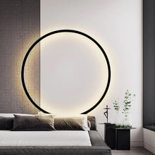 Load image into Gallery viewer, INSPIRA LIFESTYLES – Minimalist Metal Ring Light, a modern circular LED wall light with sleek sculptural design. This versatile wall sconce doubles as accent lighting and wall art, perfect as a bedroom light above a headboard, a living room statement piece, or a minimalist hallway fixture. Contemporary ring light crafted in metal with soft LED illumination, ideal for modern interiors seeking sculptural lighting, circle lights, or functional yet artistic wall sconces.
