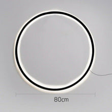 Load image into Gallery viewer, INSPIRA LIFESTYLES – Minimalist Metal Ring Light, a modern circular LED wall light with sleek sculptural design. This versatile wall sconce doubles as accent lighting and wall art, perfect as a bedroom light above a headboard, a living room statement piece, or a minimalist hallway fixture. Contemporary ring light crafted in metal with soft LED illumination, ideal for modern interiors seeking sculptural lighting, circle lights, or functional yet artistic wall sconces.
