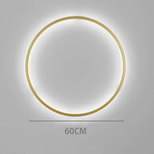 Load image into Gallery viewer, INSPIRA LIFESTYLES – Minimalist Metal Ring Light, a modern circular LED wall light with sleek sculptural design. This versatile wall sconce doubles as accent lighting and wall art, perfect as a bedroom light above a headboard, a living room statement piece, or a minimalist hallway fixture. Contemporary ring light crafted in metal with soft LED illumination, ideal for modern interiors seeking sculptural lighting, circle lights, or functional yet artistic wall sconces.
