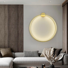 Load image into Gallery viewer, INSPIRA LIFESTYLES – Minimalist Metal Ring Light, a modern circular LED wall light with sleek sculptural design. This versatile wall sconce doubles as accent lighting and wall art, perfect as a bedroom light above a headboard, a living room statement piece, or a minimalist hallway fixture. Contemporary ring light crafted in metal with soft LED illumination, ideal for modern interiors seeking sculptural lighting, circle lights, or functional yet artistic wall sconces.

