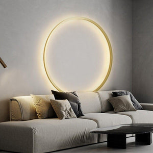 INSPIRA LIFESTYLES – Minimalist Metal Ring Light, a modern circular LED wall light with sleek sculptural design. This versatile wall sconce doubles as accent lighting and wall art, perfect as a bedroom light above a headboard, a living room statement piece, or a minimalist hallway fixture. Contemporary ring light crafted in metal with soft LED illumination, ideal for modern interiors seeking sculptural lighting, circle lights, or functional yet artistic wall sconces.