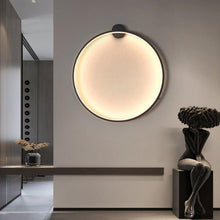 Load image into Gallery viewer, INSPIRA LIFESTYLES – Minimalist Metal Ring Light, a modern circular LED wall light with sleek sculptural design. This versatile wall sconce doubles as accent lighting and wall art, perfect as a bedroom light above a headboard, a living room statement piece, or a minimalist hallway fixture. Contemporary ring light crafted in metal with soft LED illumination, ideal for modern interiors seeking sculptural lighting, circle lights, or functional yet artistic wall sconces.
