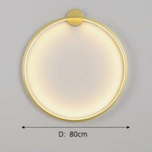Load image into Gallery viewer, INSPIRA LIFESTYLES – Minimalist Metal Ring Light, a modern circular LED wall light with sleek sculptural design. This versatile wall sconce doubles as accent lighting and wall art, perfect as a bedroom light above a headboard, a living room statement piece, or a minimalist hallway fixture. Contemporary ring light crafted in metal with soft LED illumination, ideal for modern interiors seeking sculptural lighting, circle lights, or functional yet artistic wall sconces.
