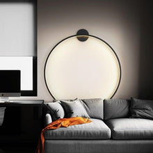 Load image into Gallery viewer, INSPIRA LIFESTYLES – Minimalist Metal Ring Light, a modern circular LED wall light with sleek sculptural design. This versatile wall sconce doubles as accent lighting and wall art, perfect as a bedroom light above a headboard, a living room statement piece, or a minimalist hallway fixture. Contemporary ring light crafted in metal with soft LED illumination, ideal for modern interiors seeking sculptural lighting, circle lights, or functional yet artistic wall sconces.
