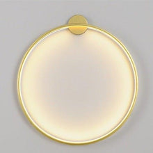 Load image into Gallery viewer, INSPIRA LIFESTYLES – Minimalist Metal Ring Light, a modern circular LED wall light with sleek sculptural design. This versatile wall sconce doubles as accent lighting and wall art, perfect as a bedroom light above a headboard, a living room statement piece, or a minimalist hallway fixture. Contemporary ring light crafted in metal with soft LED illumination, ideal for modern interiors seeking sculptural lighting, circle lights, or functional yet artistic wall sconces.
